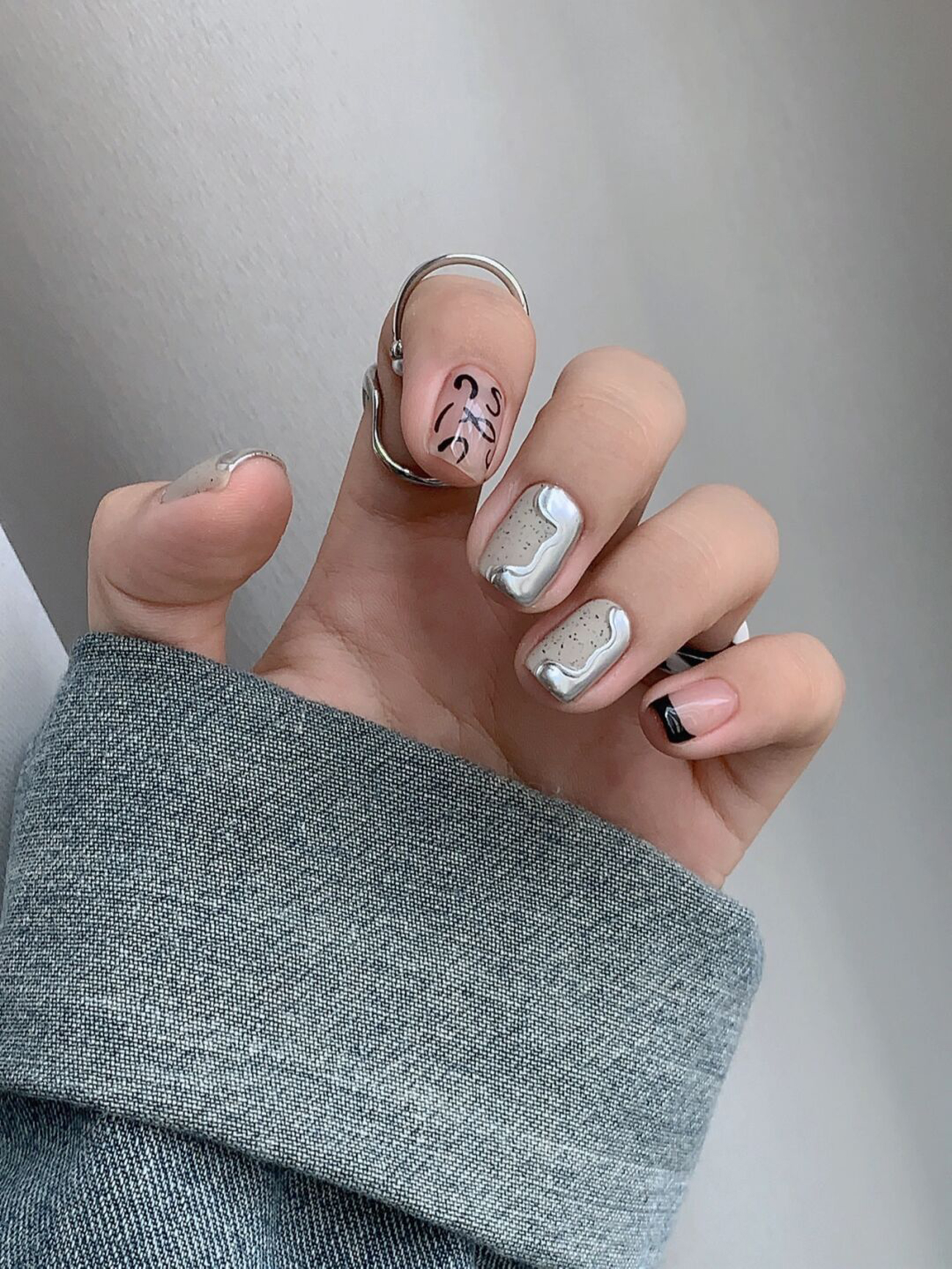 Black and Nude Abstract Square Nails shown as a nail art design with black, nude, abstract, minimal, swirl, square and medium details.