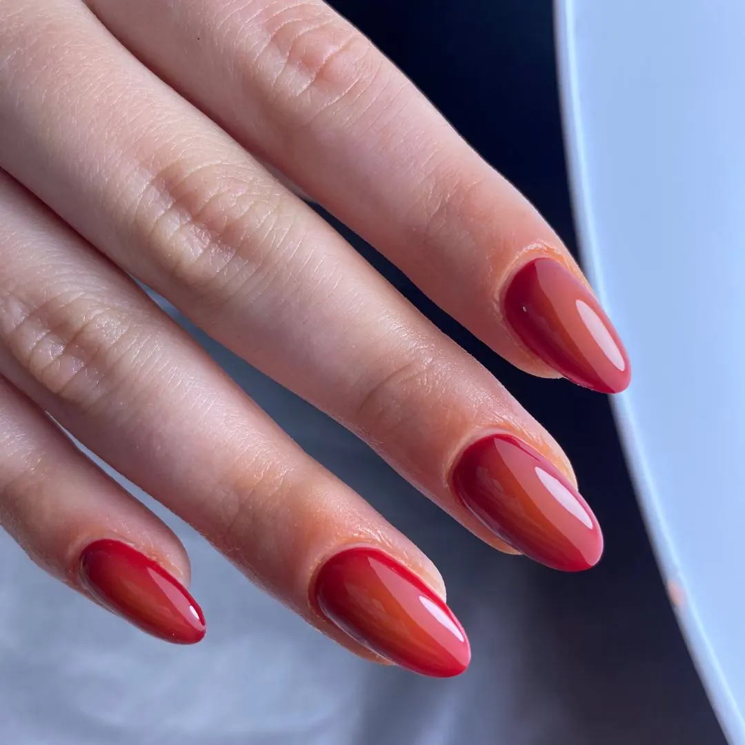 Glossy deep red gel manicure on medium almond-shaped nails