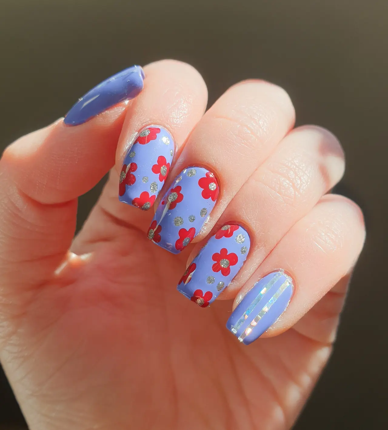 Periwinkle square nails with red floral art silver glitter dots and reflective foil striping