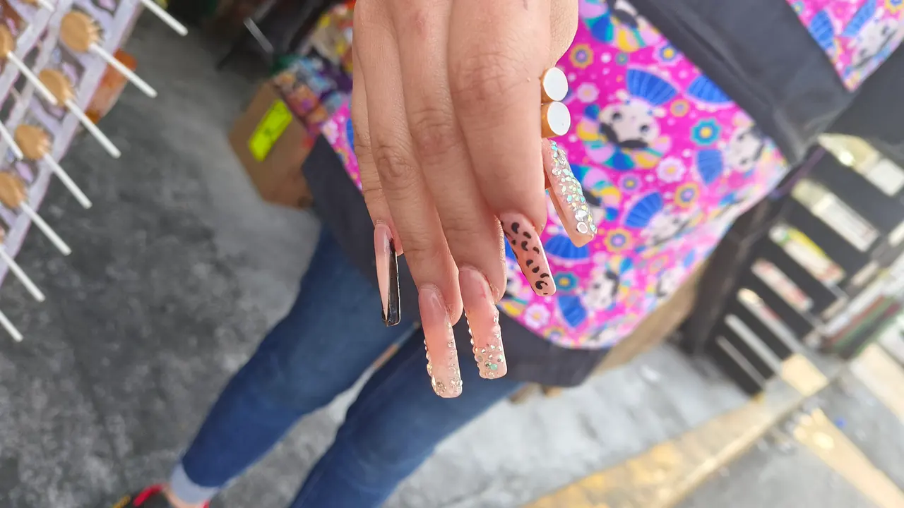 Red, blue, and white graphic nail art on medium almond-shaped nails